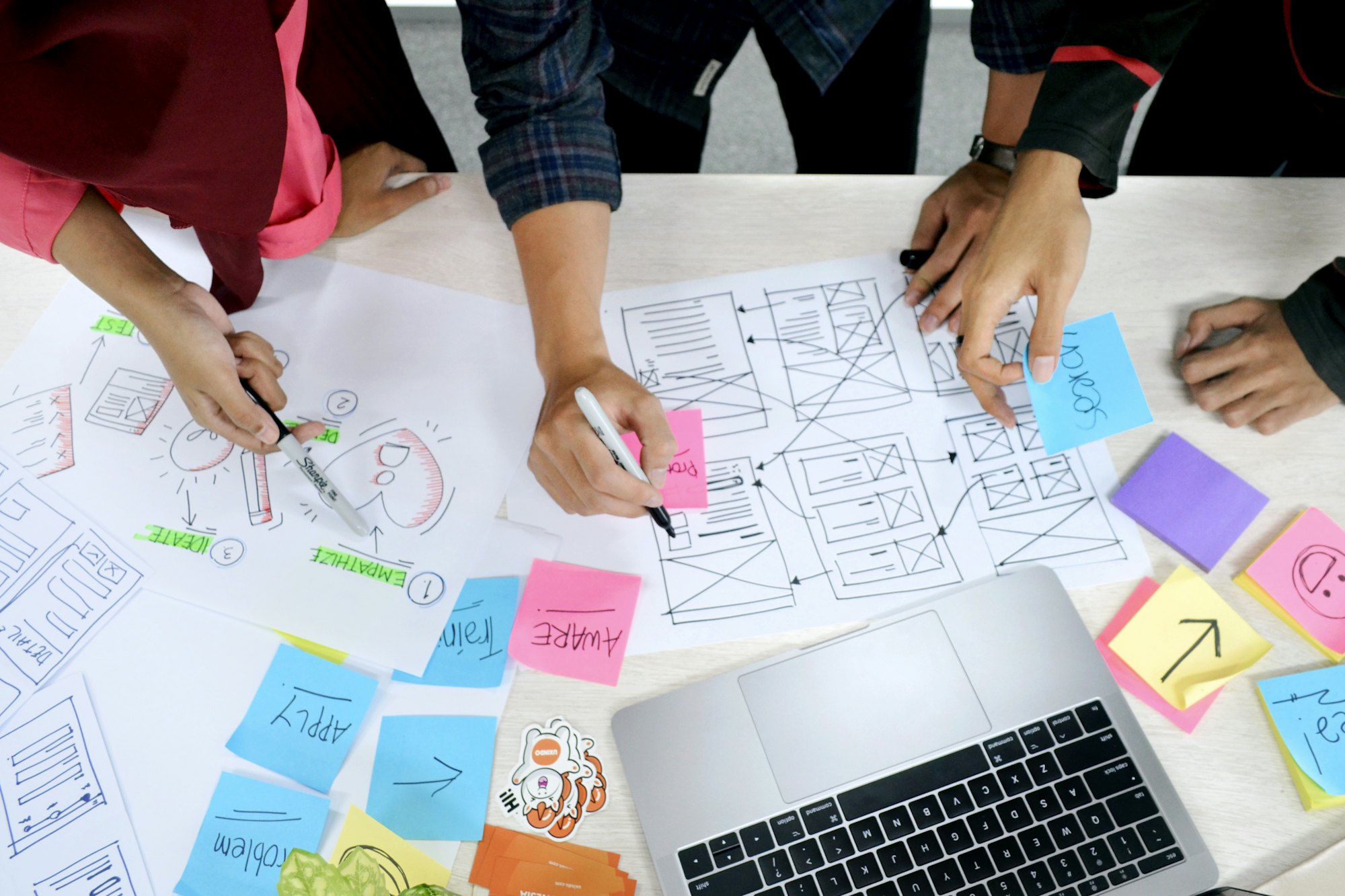 An overhead view of a wireframing session in progress